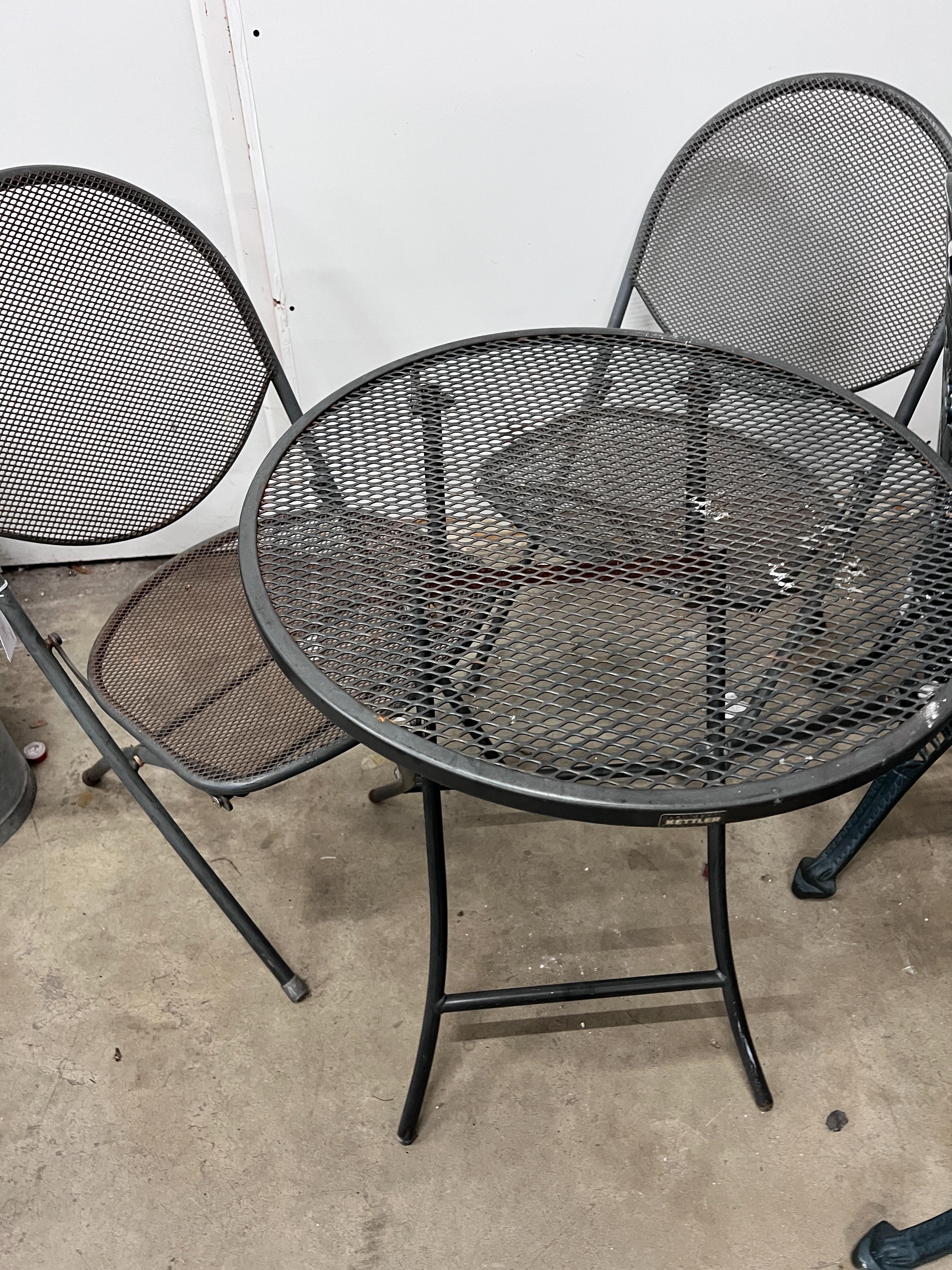 A Kettler circular garden table, diameter 62cm, height 72cm and two chairs